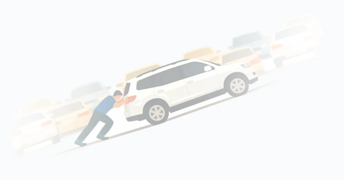 A man pushing a car uphill, searching for parking